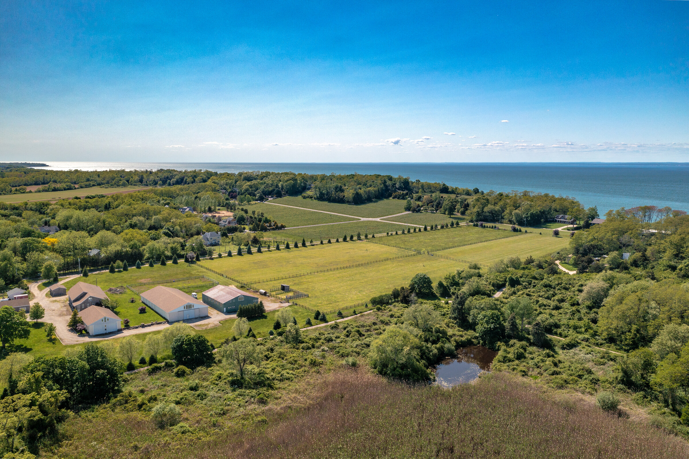 Aerial view of the equestrian fields with the Sound visible