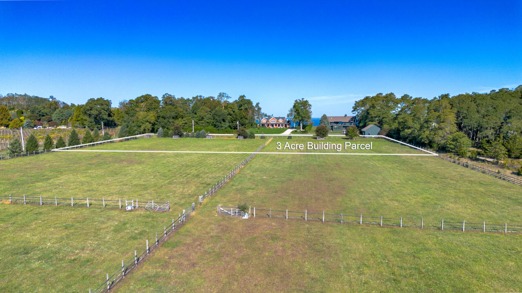 Aerial showing the 3-acre buildable parcel at the rear of the property