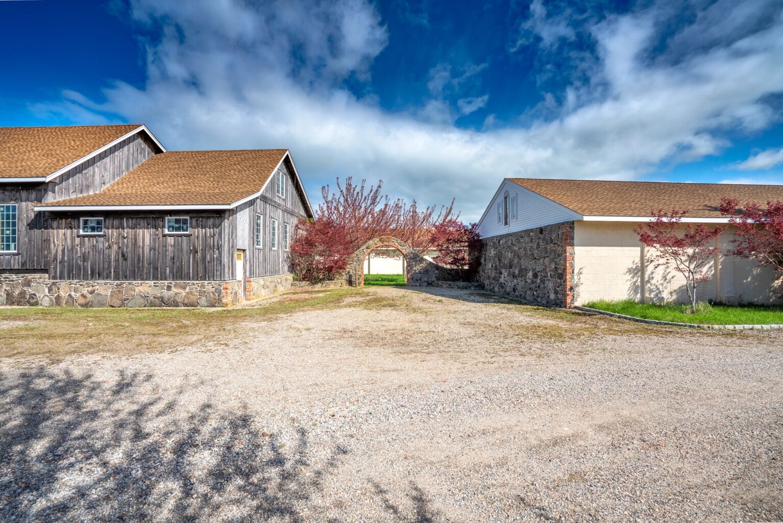 The main barn and stone arch passage as they stand today