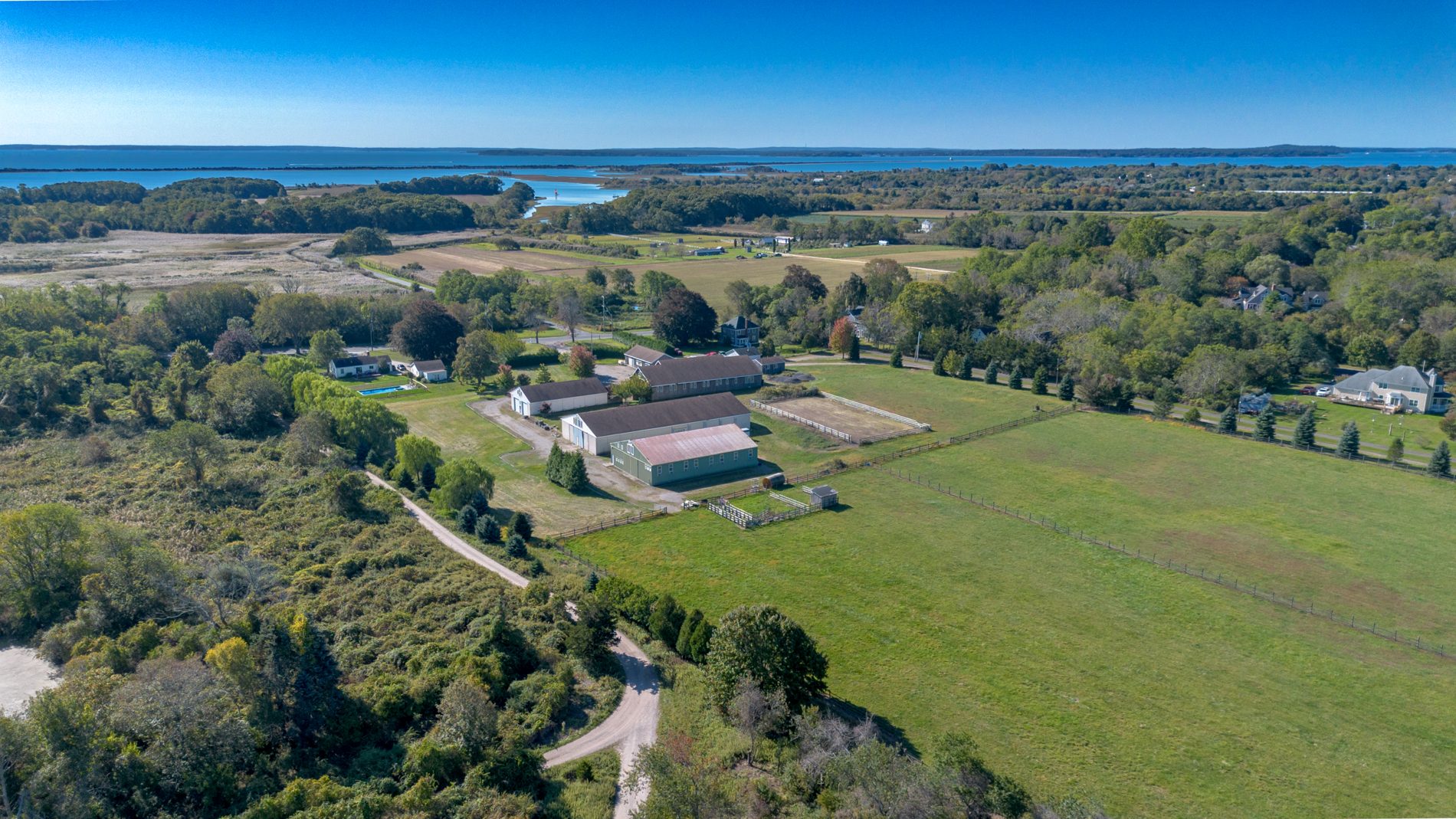 Drone view across the estate fields toward the water