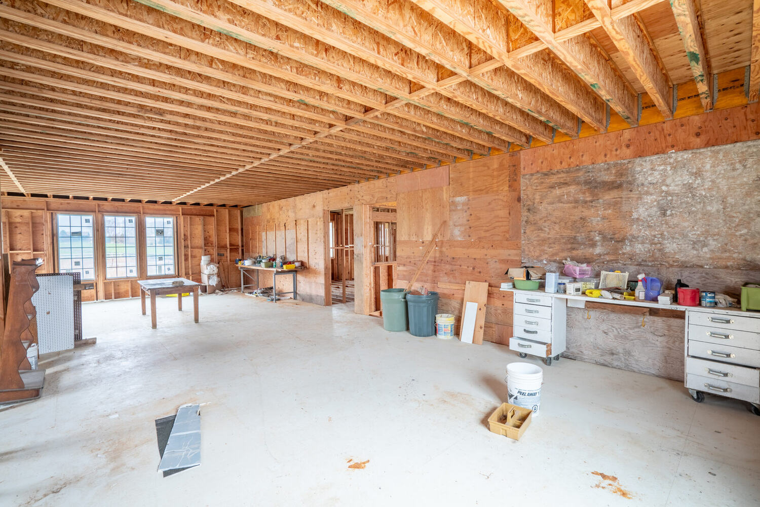 A framed room inside Building 2 with windows on two walls