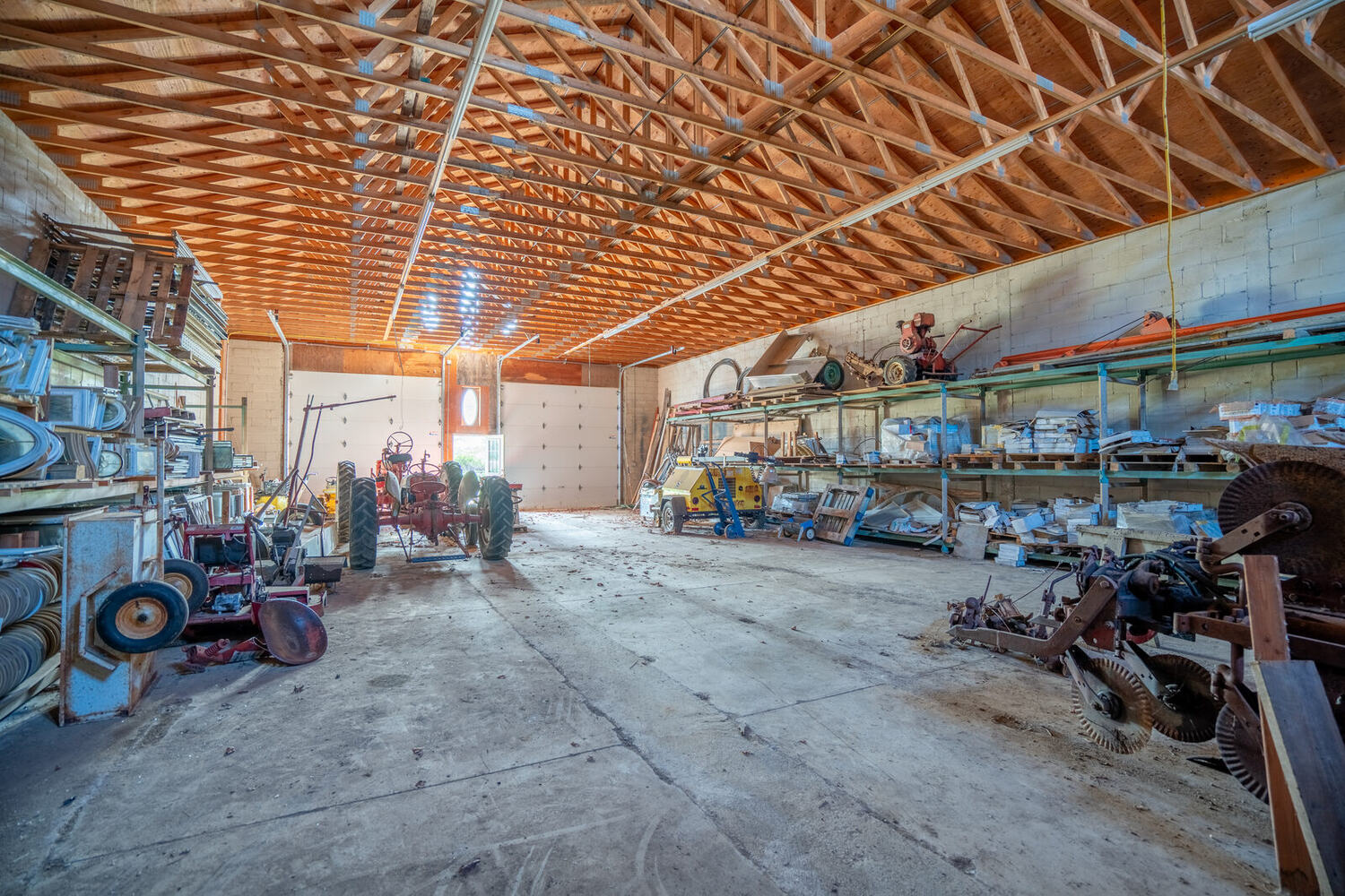 Building 3 interior with farm equipment under the trusses