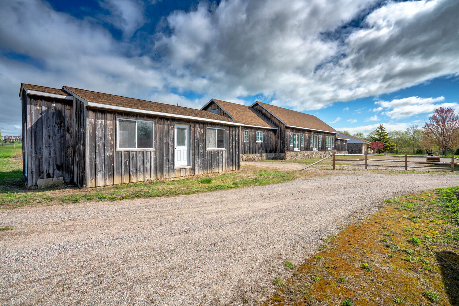 The storage shed along the gravel drive