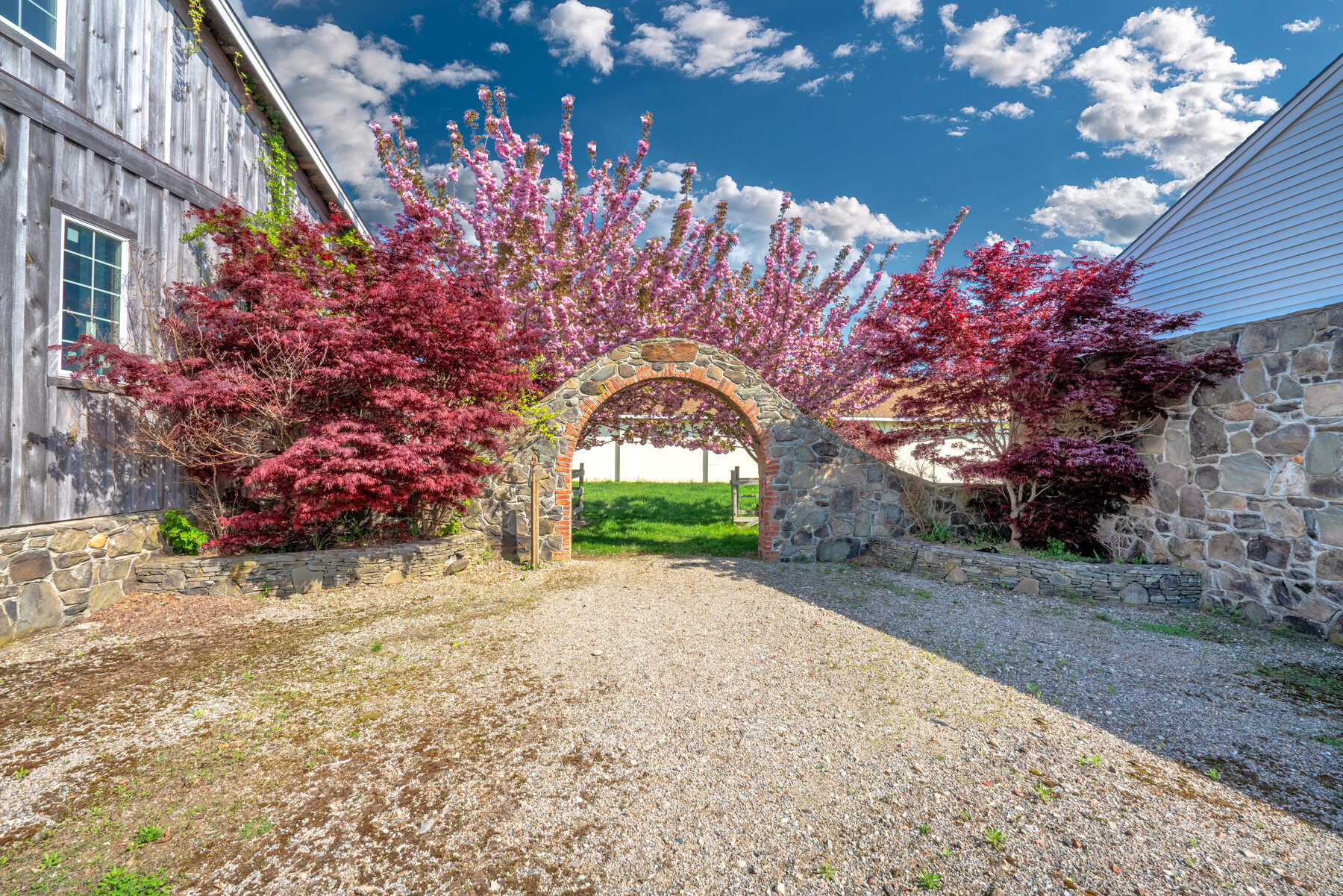The freestanding stone arch beside Building 3 in spring